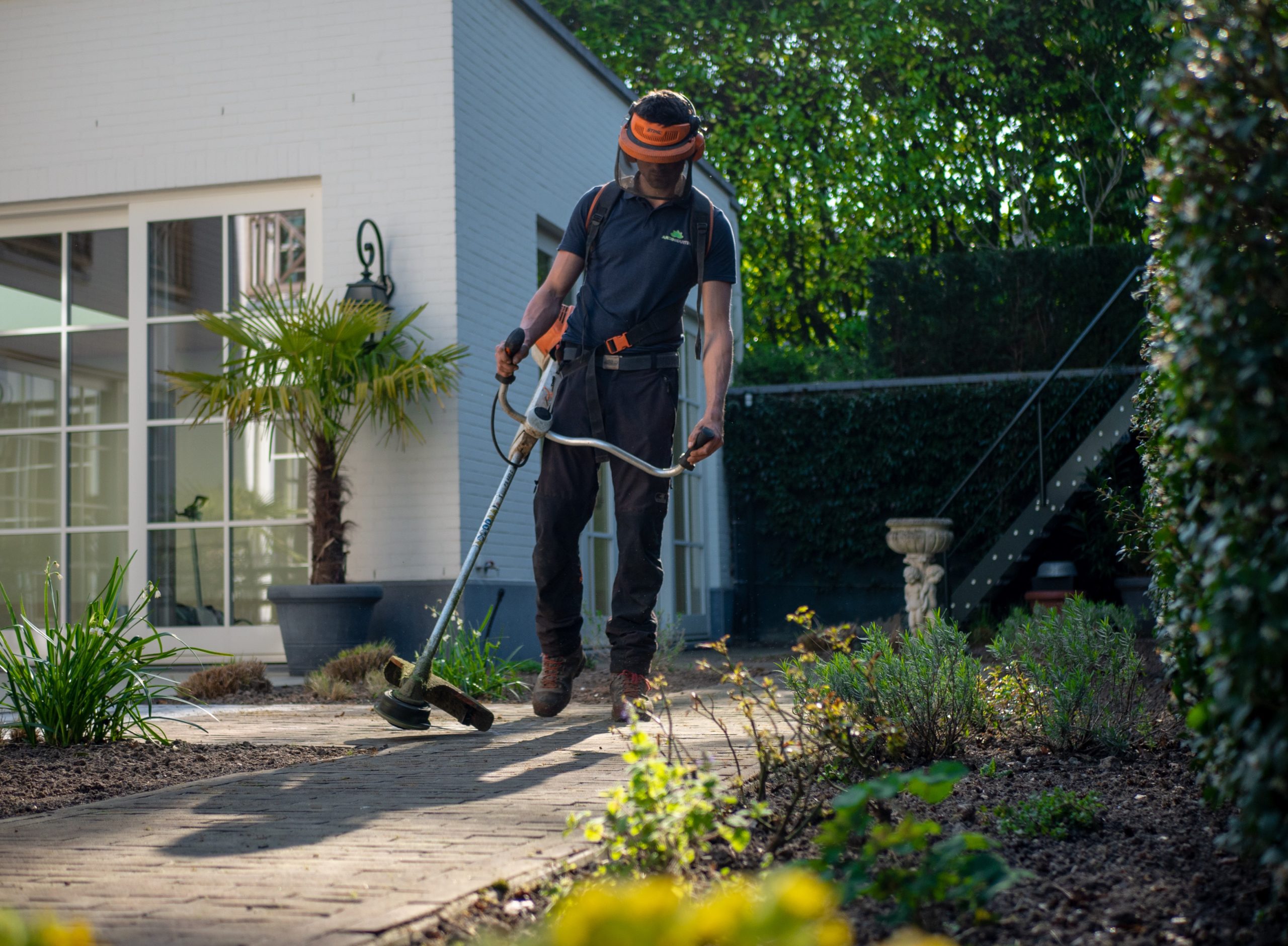 Man performing lawn maintenance at a rental property