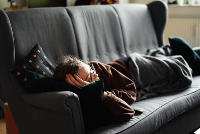 person staying on couch that won't leave rental property