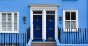 blue exterior of rental property owned by buy and hold investor
