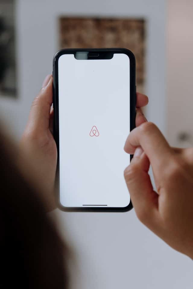 phone with airbnb logo property management for bookings