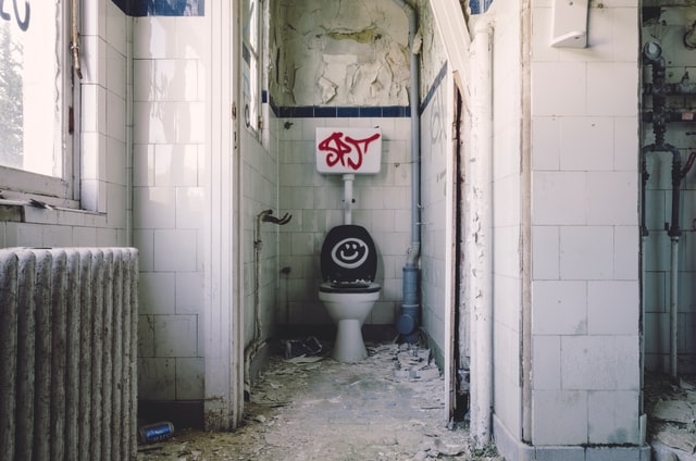 vacant, distressed property with toilet and graffiti after evicting squatters without a lease 