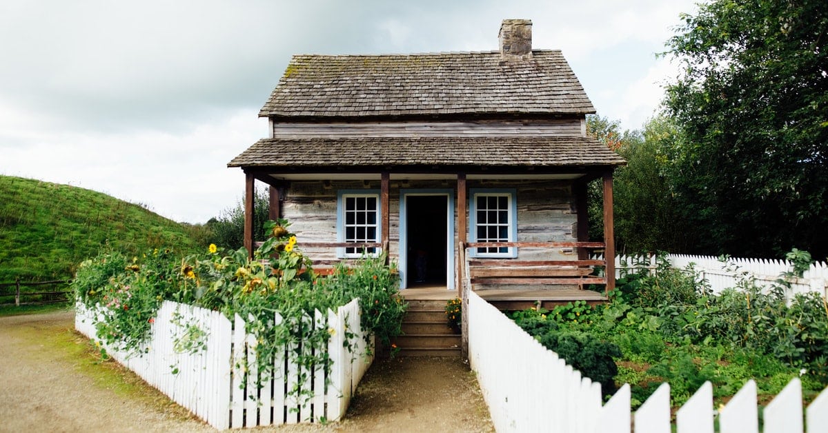 house with white fence bought for back taxes