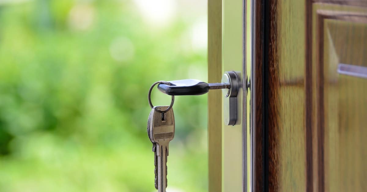 keys hanging in an open door of a property in a trust
