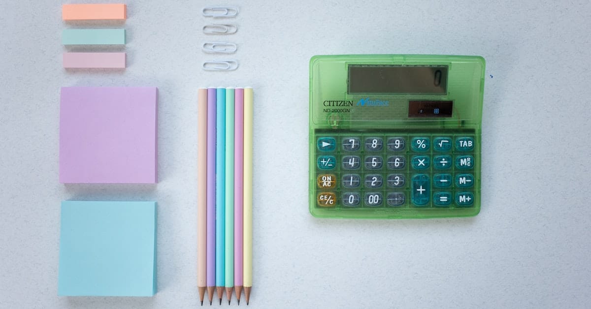 calculator post it notes and utensils for calculating rental property profit