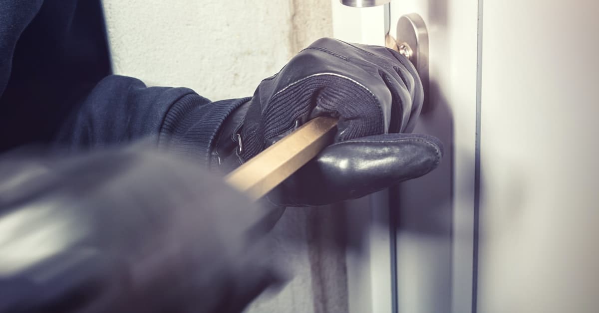 man breaking in to home covered by rental property insurance