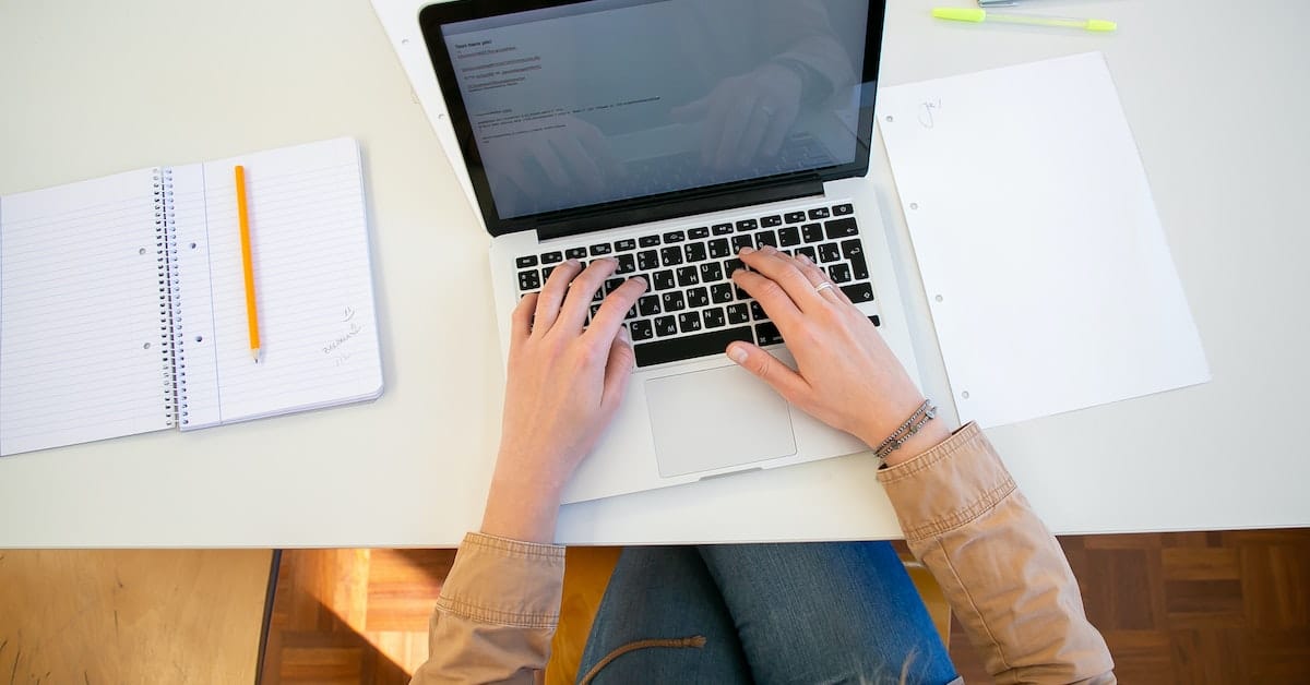 person taking real estate licensing course on a laptop