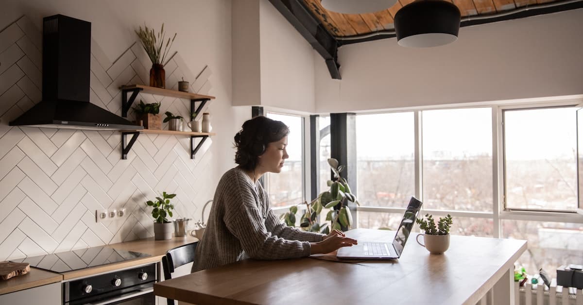 woman on computer in sunny kitchen searching for framing contractors near me