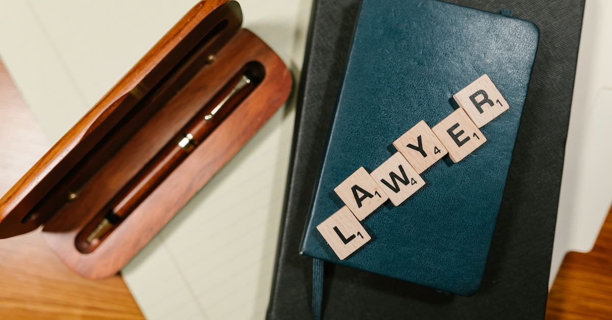 pen and scrabble letters spelling lawyer on book for landlord tenant lawyer
