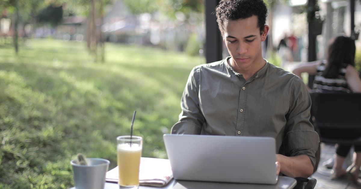 man sitting outside on laptop writing 60 day notice to quit
